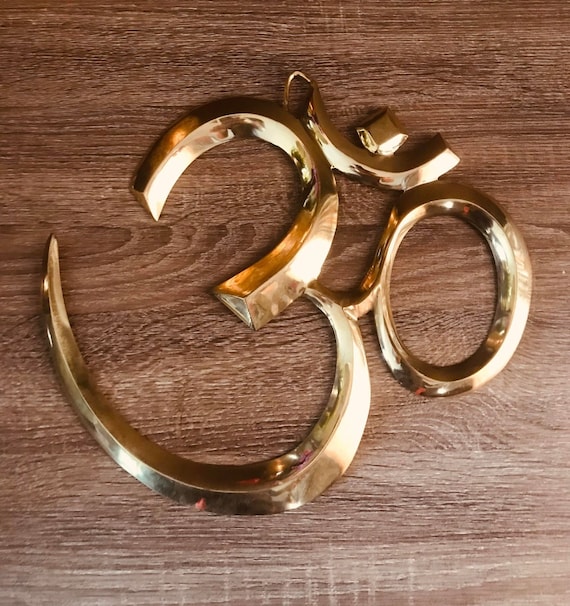 brass om wall hanging