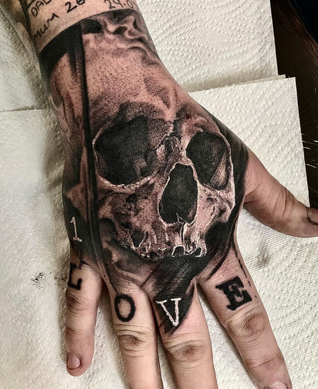 skull hand tattoo