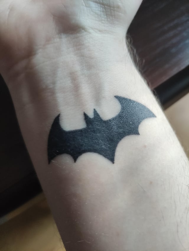 small batman symbol tattoo