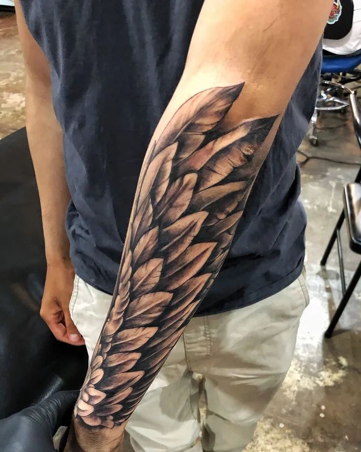 wings on forearm tattoo